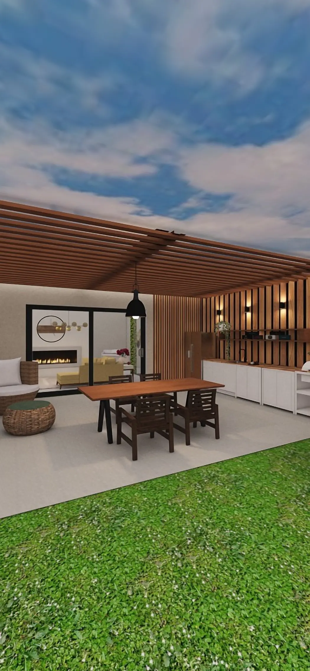 A covered patio with a dining table under a wood pergola, next to the lawn